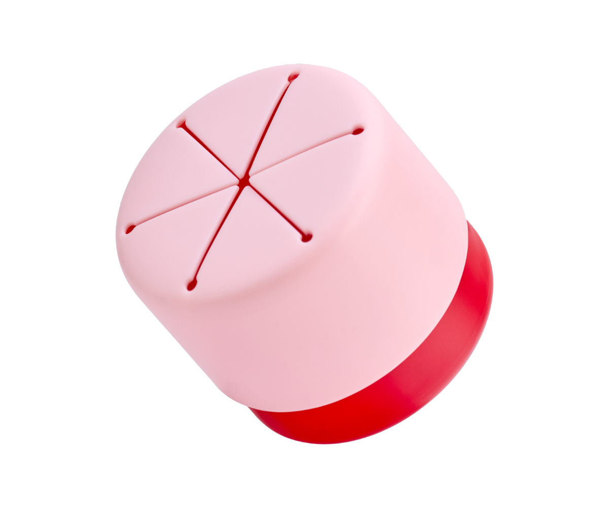 Tilted snack cup with red underneath and pink lid